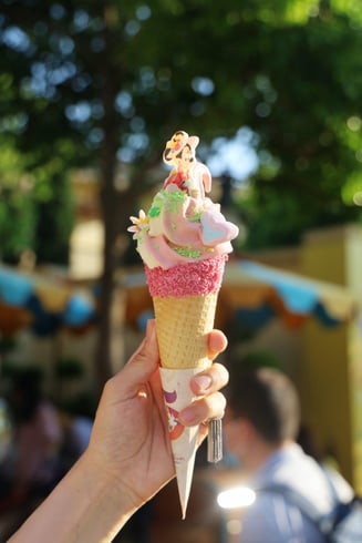 An ice cream cone with a Minnie Mouse decoration.